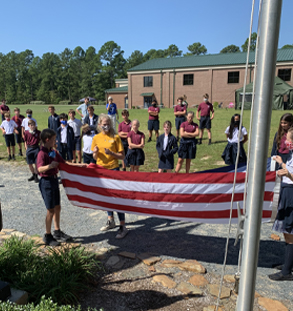 Group of students folding American Flag
